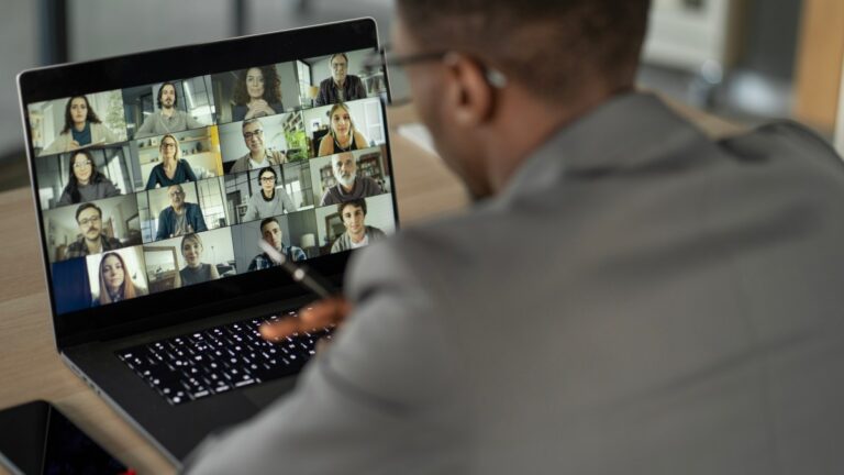 Man sitting at desk participating in an online meeting.