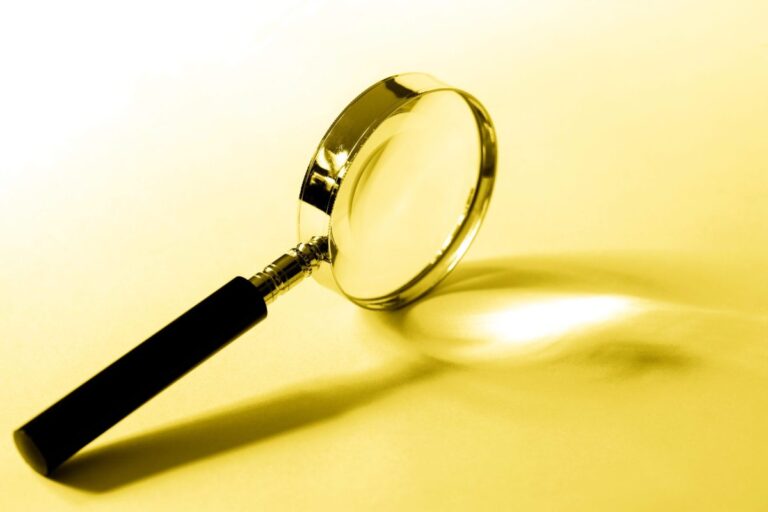 Image of a magnifying glass on a white and yellow background.