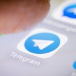 Photo illustration of the Telegram app icon on a smartphone
